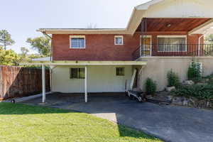Back of property featuring brick siding and driveway