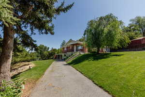 View of front of home with a front lawn and asphalt driveway