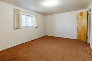 Empty room with carpet and baseboards