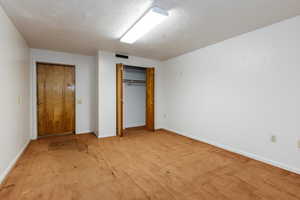 Unfurnished bedroom with carpet and a closet