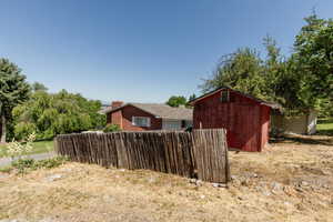 View of home's exterior featuring a storage unit
