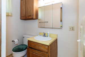 Half bathroom featuring toilet and vanity