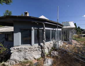 View of side of home featuring a sunroom and a chimney