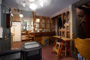 View of kitchen featuring freestanding refrigerator craftsman cabinets