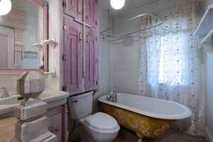 Bathroom with a clawfoot tub and vanity