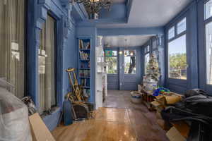 Sunroom entrance with a chandelier and hardwood flooring