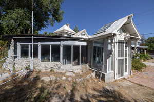 Rear view of property featuring a sunroom