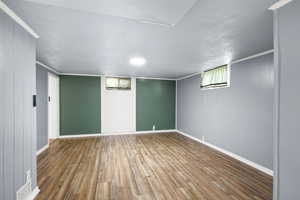 Basement featuring hardwood / wood-style flooring and baseboards