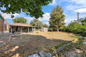 View of yard with a storage unit