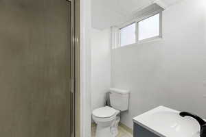 Full bath with vanity, tile patterned flooring, and a shower with shower door