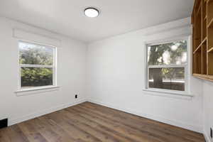 Unfurnished room featuring dark wood-type flooring
