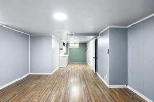 Basement featuring wood finished floors and baseboards