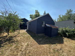 View of property exterior with a yard