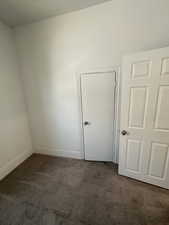 Carpeted spare room with baseboards