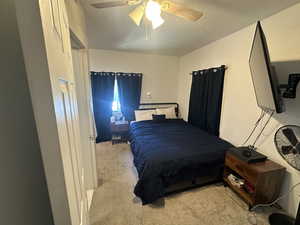 Bedroom with carpet and a ceiling fan