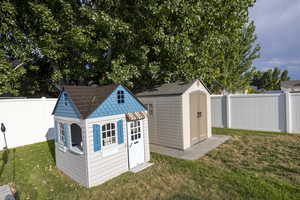 View of shed with a fenced backyard