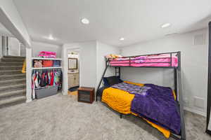 Bedroom featuring carpet, recessed lighting, and ensuite bath