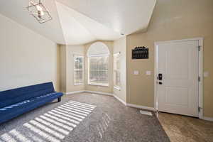 Foyer with lofted ceiling and a textured ceiling