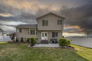 Back of property featuring a patio area, a fenced backyard, and entry steps