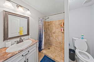 Bathroom featuring vanity and a tile shower