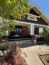 Front view of house with a porch and brick