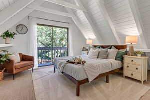 Bedroom featuring balcony and light colored carpet