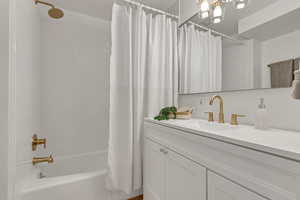 Full bathroom with vanity and shower / bath combination with curtain