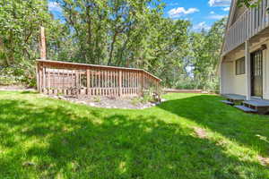 View of green lawn with a deck