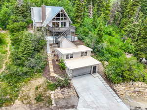 View from above of property with a forest