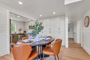 Dining area featuring light wood finished floors and recessed lighting