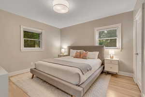 Bedroom featuring light wood-type flooring and baseboards