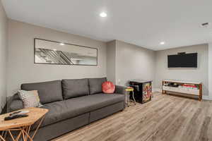Living room featuring wood finished floors and recessed lighting