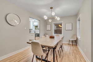 Dining space featuring light wood finished floors and a chandelier