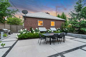 Patio terrace at dusk with outdoor dining space, a patio area, and area for grilling