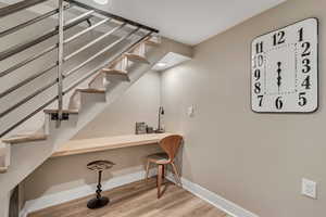 Stairway featuring baseboards and wood finished floors