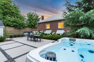 View of patio / terrace featuring a hot tub and outdoor dining area
