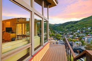 Deck at dusk featuring a mountain view