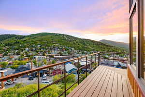 Balcony at dusk featuring a mountain view