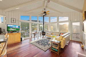 Living area featuring wood finished floors, healthy amount of natural light, and ceiling fan