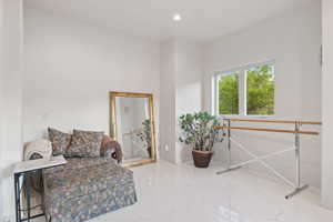 Sitting room featuring marble tiled floors and recessed lighting