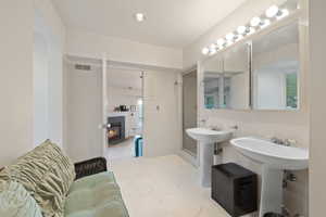 Bathroom with a tiled fireplace and recessed lighting