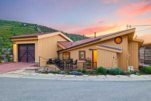 View of front of home with a garage and decorative driveway
