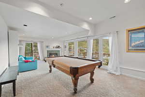 Recreation room with carpet, billiards table, a tiled fireplace, and recessed lighting