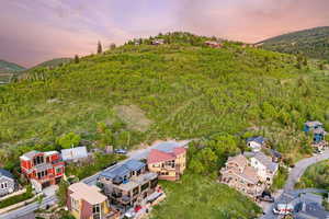 Aerial view at dusk of a wooded view, a residential view, and a mountain view