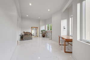 Hallway featuring recessed lighting and marble tiled floors