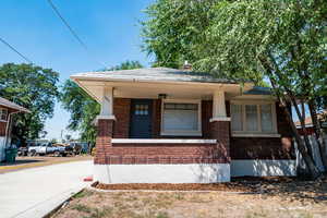 View of front facade with brick siding and covered porch