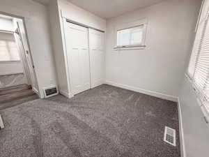 Unfurnished bedroom featuring a closet and carpet floors