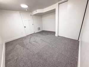 Finished basement with carpet floors and baseboards