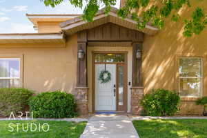 View of exterior entry with stucco siding