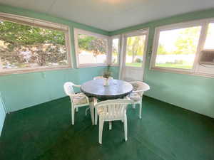Sunroom featuring carpet floors and plenty of natural light